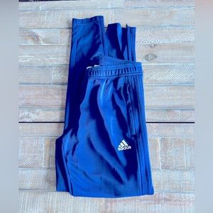 Adidas blue track pants w/blue stripes size SM. Polyester w/zippers at ankles.